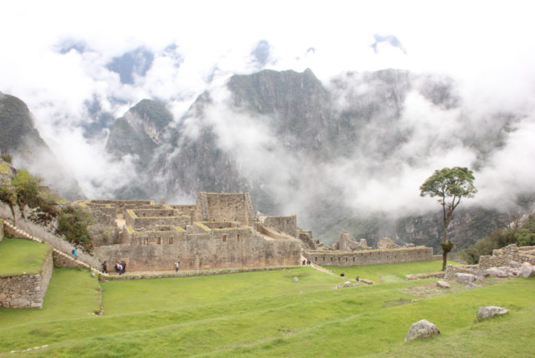 Machu Picchu ruins with fog clouding the wayna picchu Mountain
