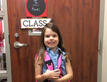 young girl makes a funny face on her first day of Prek