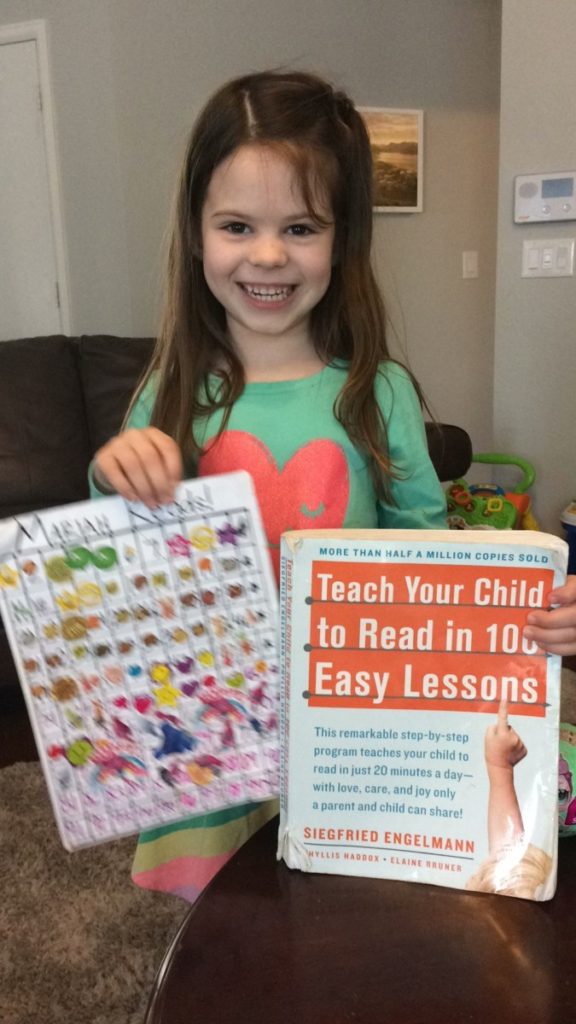 a girls smiles with the teach your child to read in 100 easy lessons book