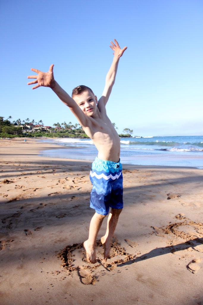 boy jumping on a beach