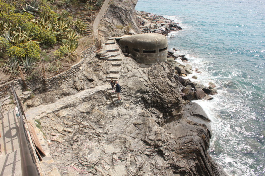 a dad and son on the coastal hike between Vernazza and Corniglia with a war bunker, Cinque Terre Italy