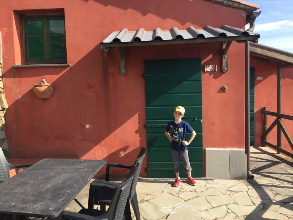 Campo Di Borgi Hotel room with a loft bed and patio furniture