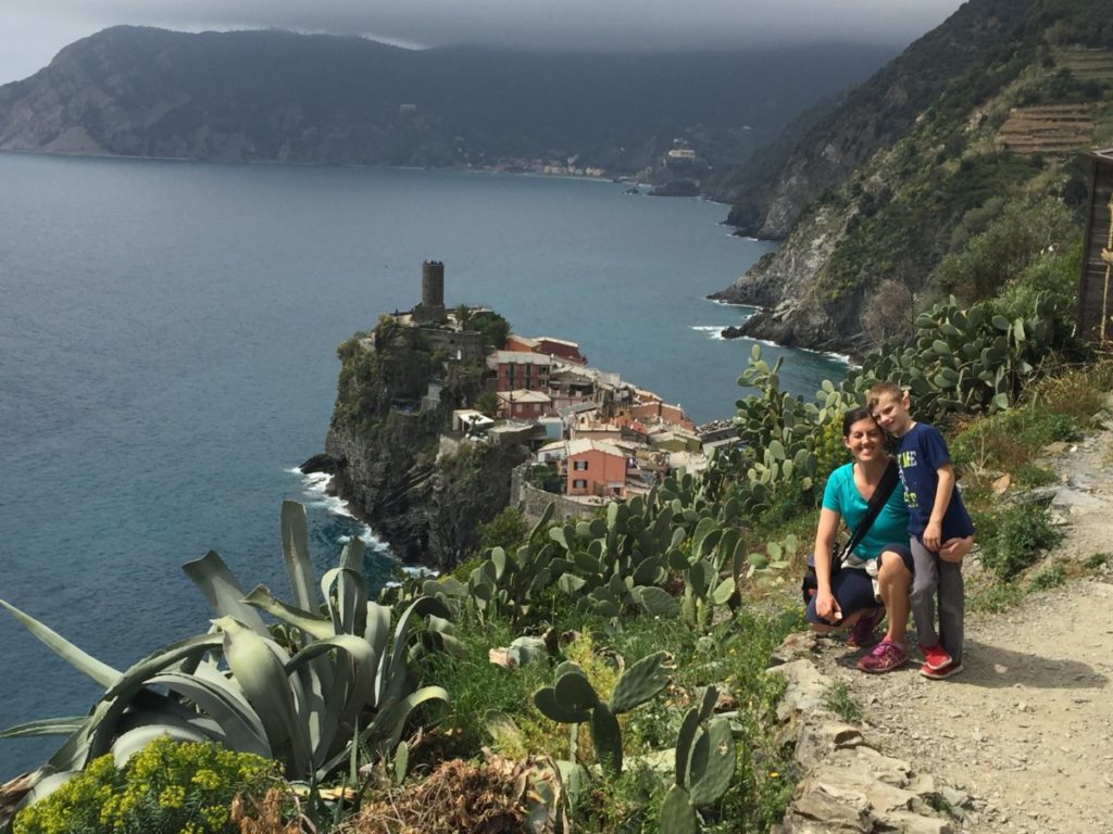 A mom and son hiking with the view of Vernazza and Monterosso in the background, Cinque Terre, Italy