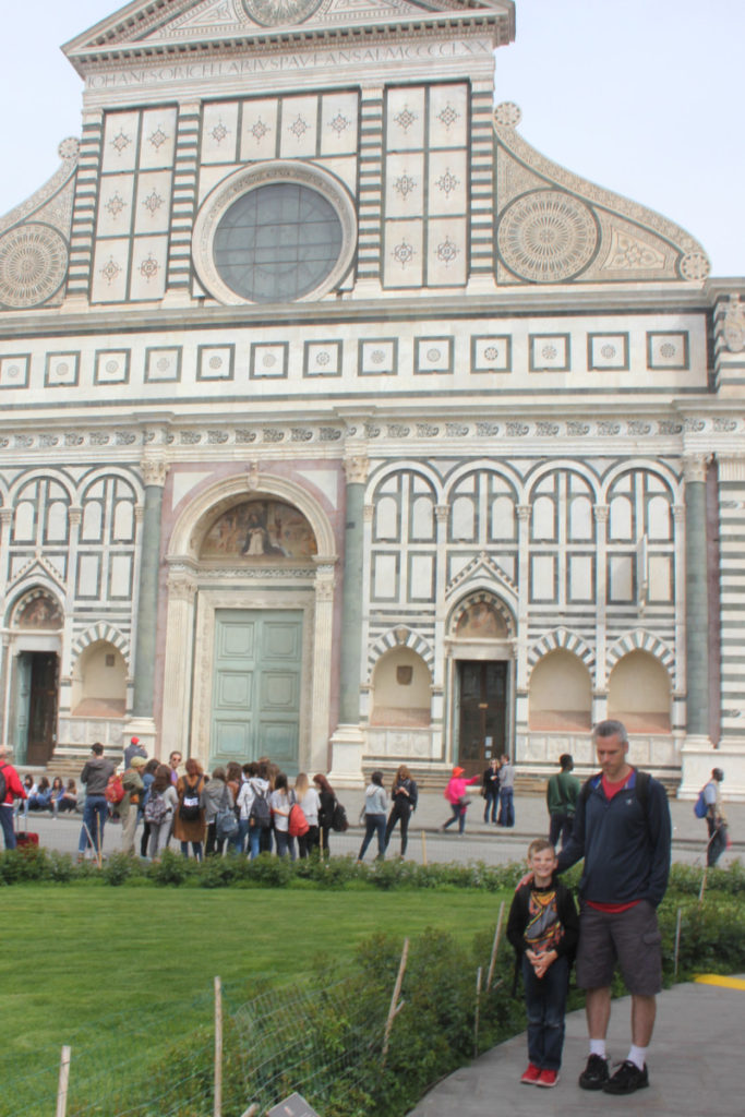 A Dad and son stand in front of Santa Croce in Florence 