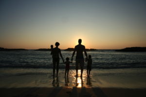 family of 5 silhouette in the sunset on Ko'olina beach, Oahu, Hawaii