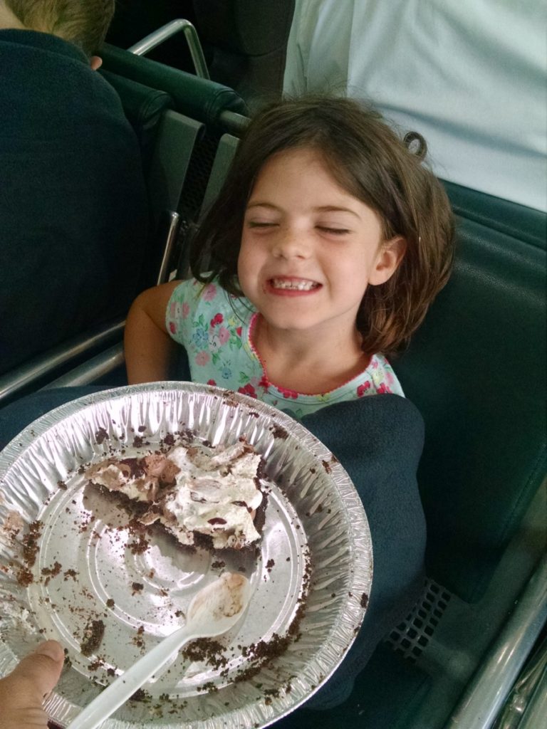 a Sleepy girl at Knoxville airport eats chocolate pie for breakfast