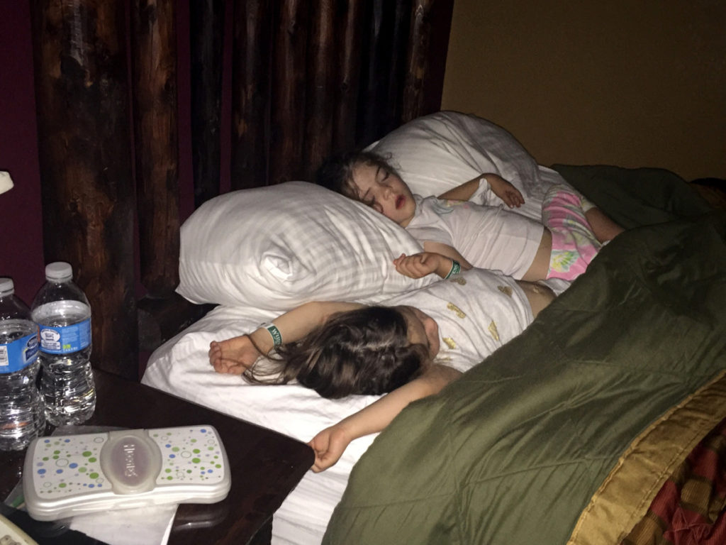 2 girls sleep sharing a hotel bed