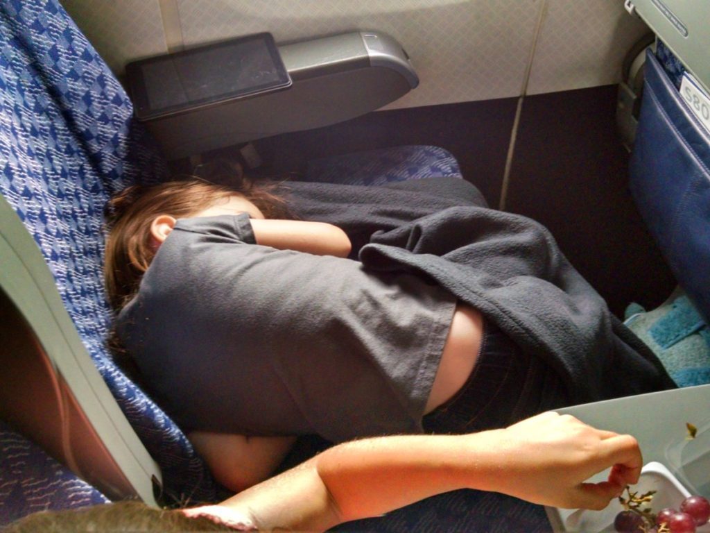 Young girl Sleeps in a seat on an Airplane
