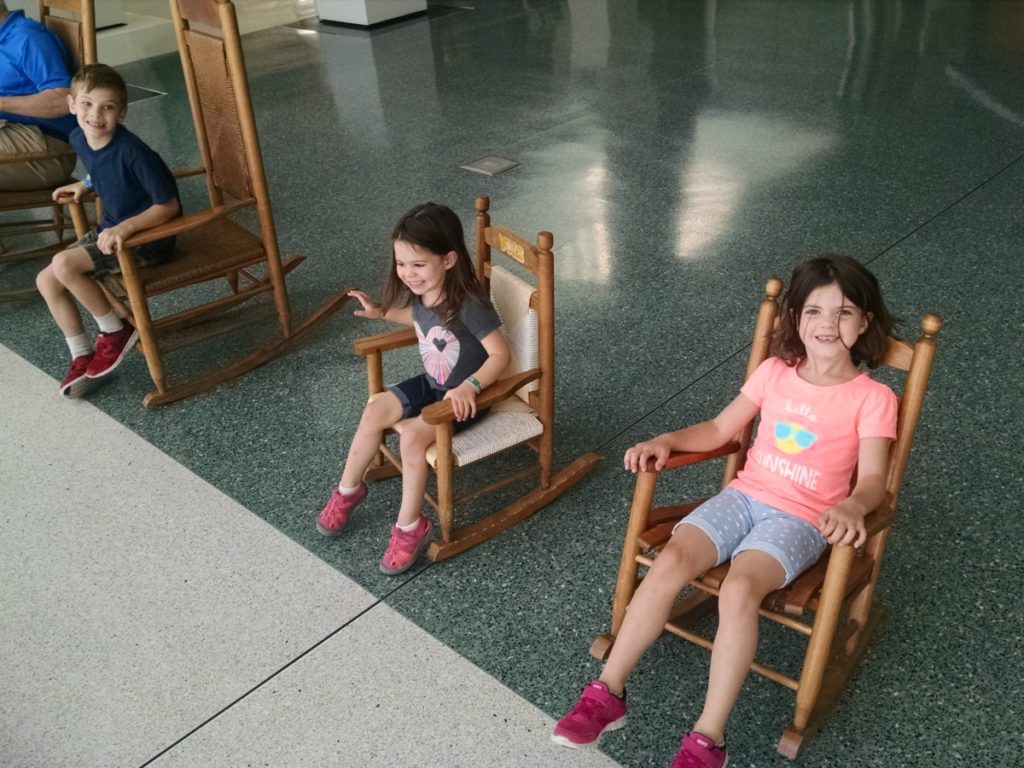 3 kids in Rocking Chairs at the Knoxville Airport