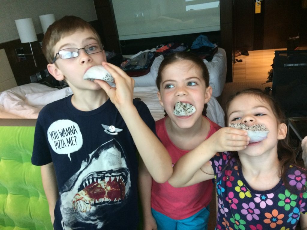 3 young kids eat dim sum in Hong Kong