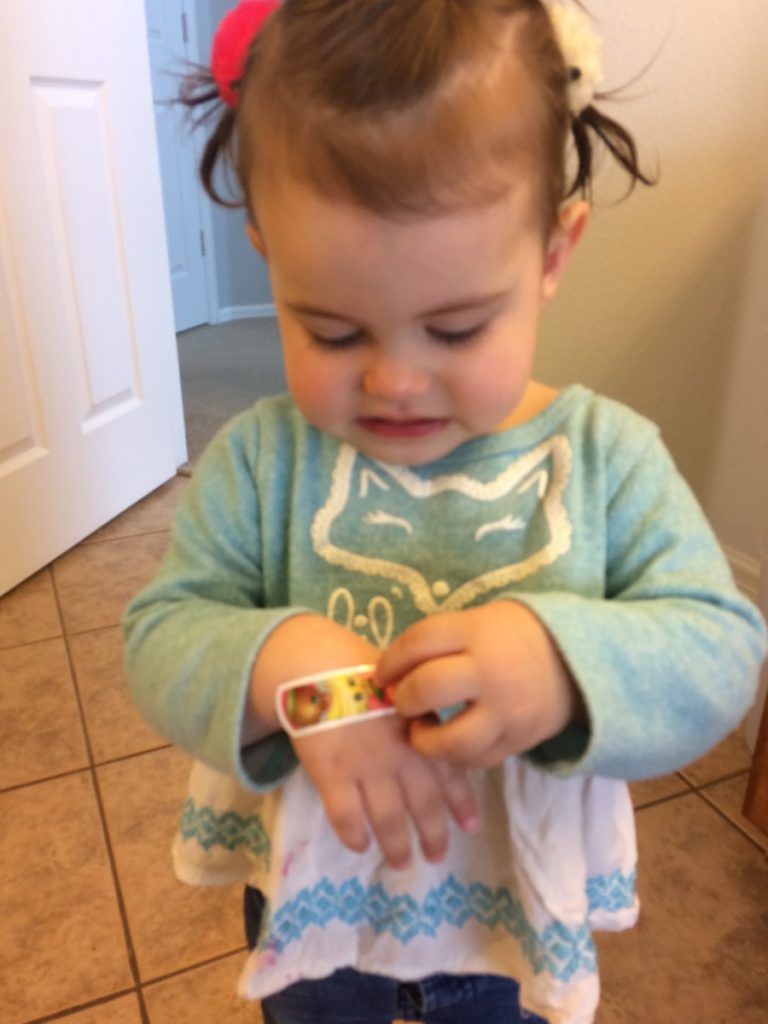 Toddler with a bandaid on her hand