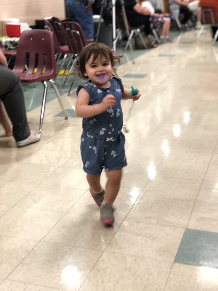 A Toddler Runs through a school cafeteria
