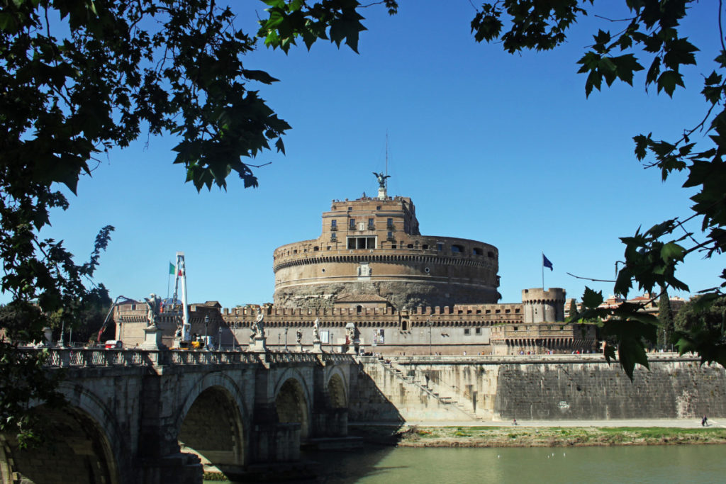 Castel Snat'Angelo with the bridge and river frames by trees in Rome, Italy