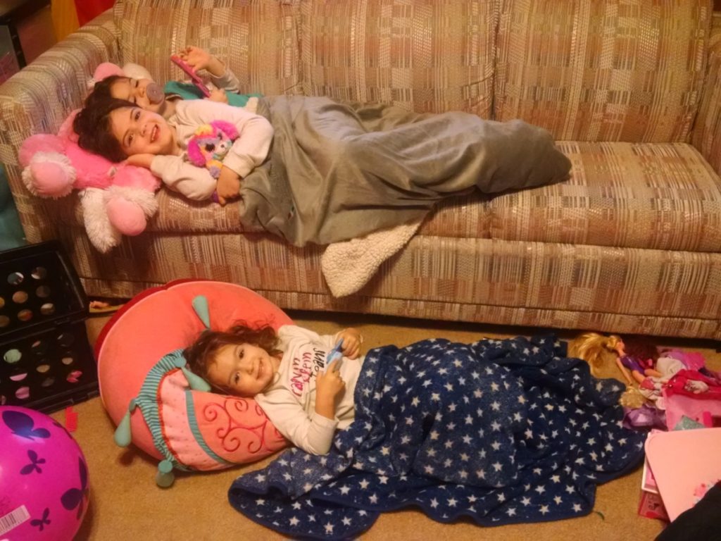 3 girls sleep over on a couch