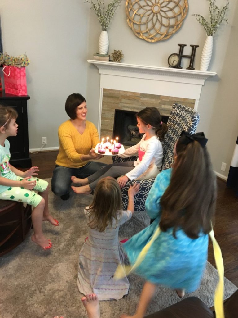 singing happy birthday to a young girl at a spa treatment birthday party