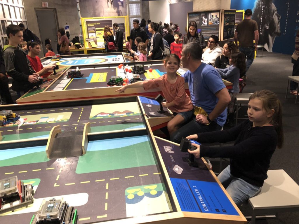 children control robots in a game at the Perot musuem