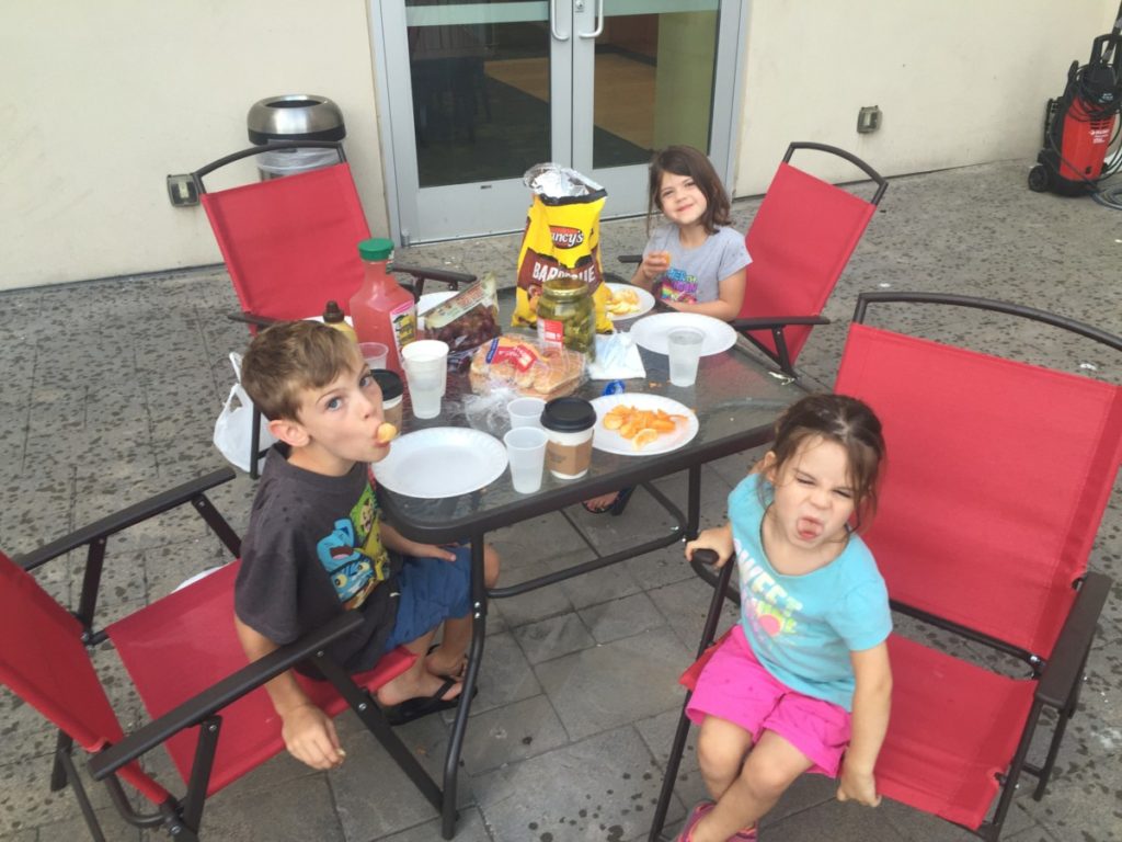 3 kids eat a BBQ at a hotel in Seattle