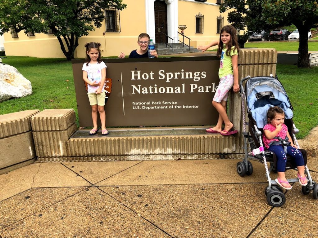 4 kids in front of Hot Springs National Park sign