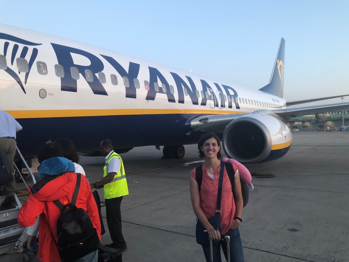 A Woman on the tarmac in front of Ryan Air Plane