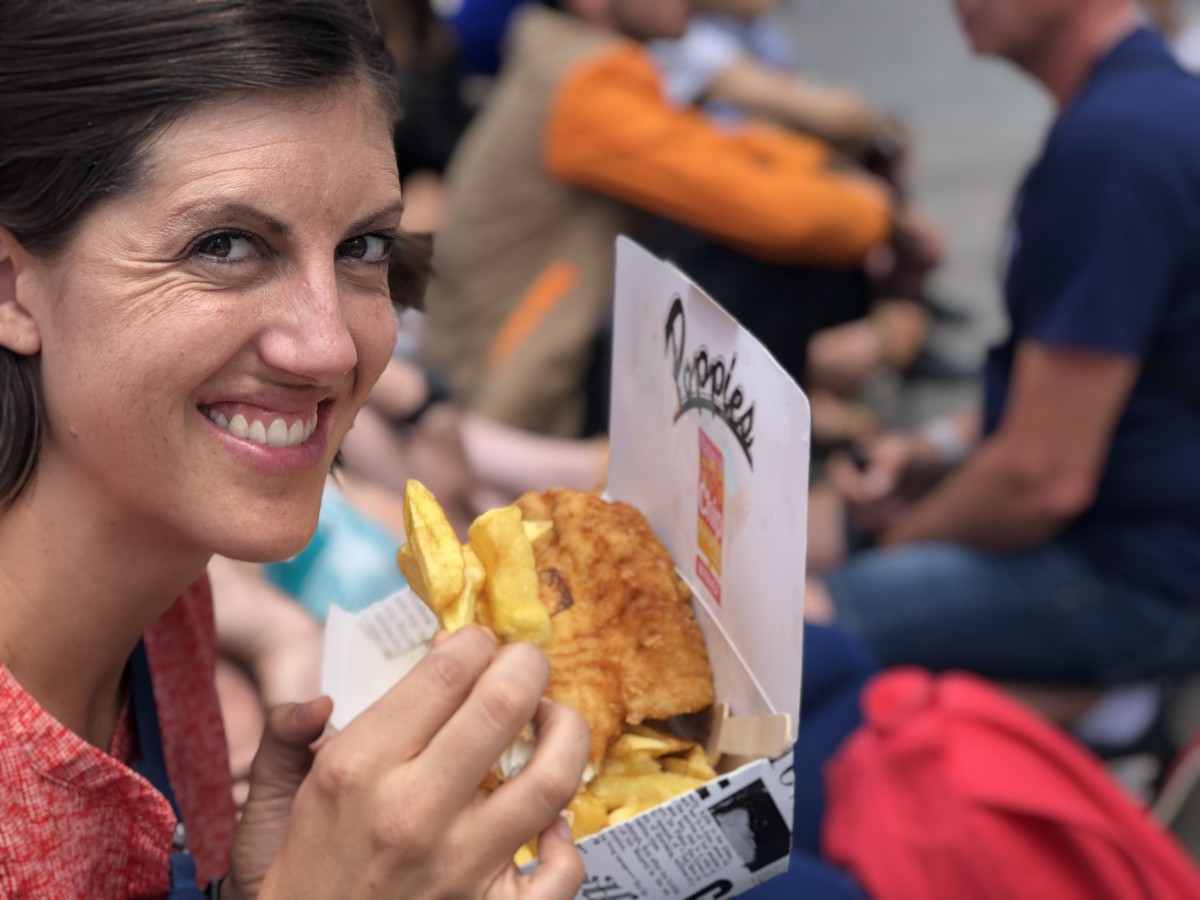 A woman eats Fish and Chips in London, Britain, United Kingdom