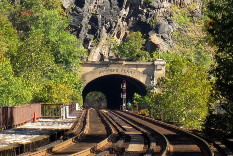 Train tracks leading to the bridge under the mountain at Harper's ferry, Virginia