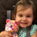 Smiling baby with a stuffed animal
