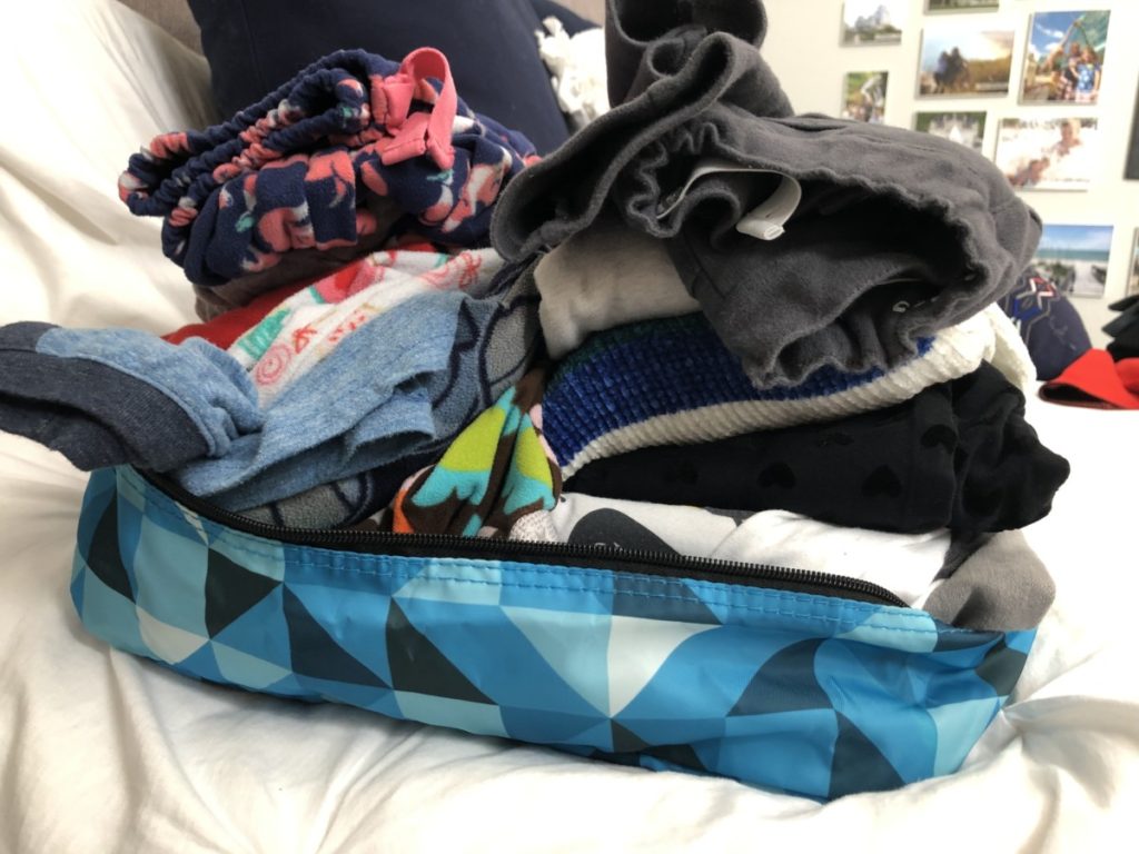 Packing cube with kids clothes in it