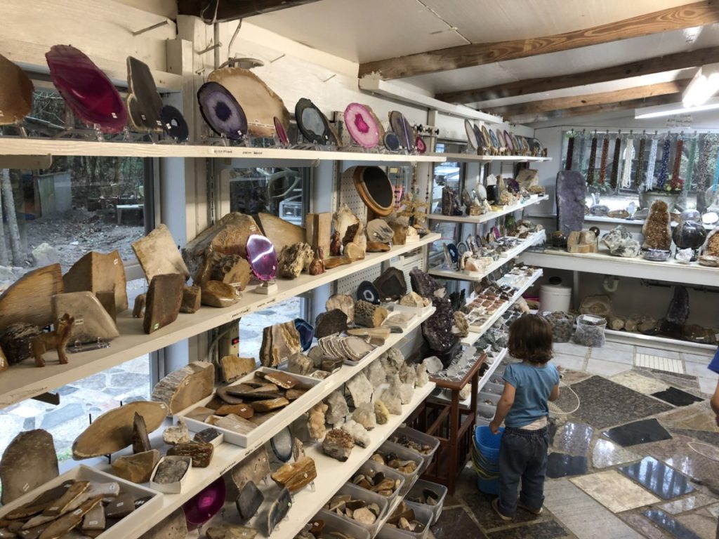 A Toddler examines the many varieties of rocks for sale at rocks, necklaces, geodes and crystals at Johnson's Rock Shop in Livingston, Texas