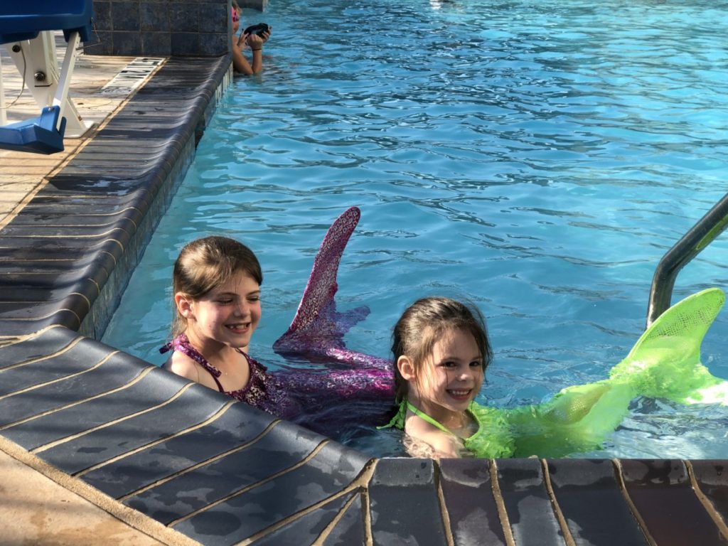 2 girls dressed like mermaids at a Hyatt Hotel Pool