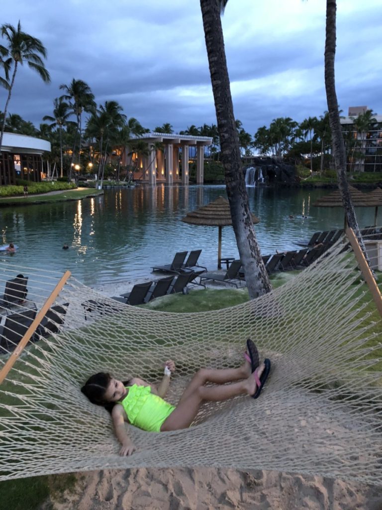 a girl in a swimsuit relaxing in the Hammock at Hilton Waikoloa