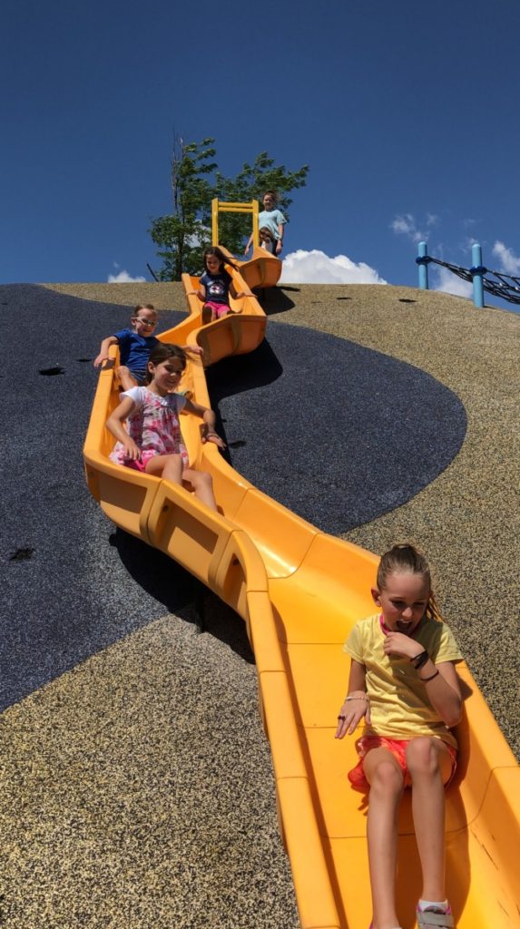 5 youngs girls on a Long slide at Philip Park in Castle Rock, Colorado