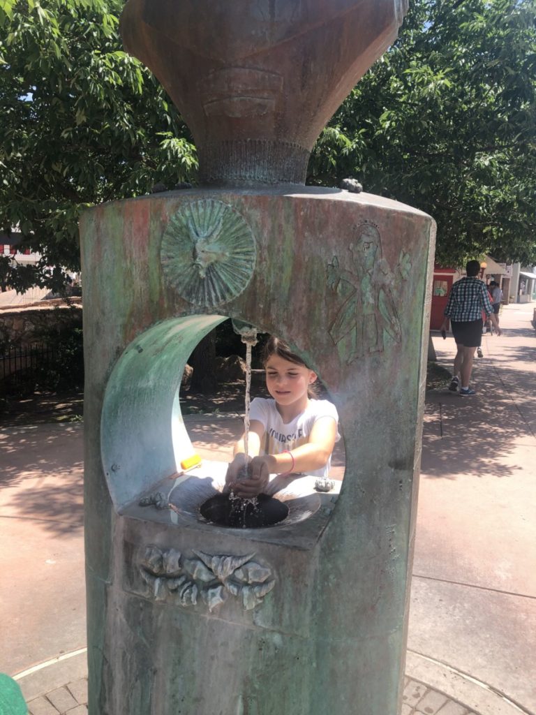 A girl takes a drink of the natural water spring in Manitou Springs, Colorado