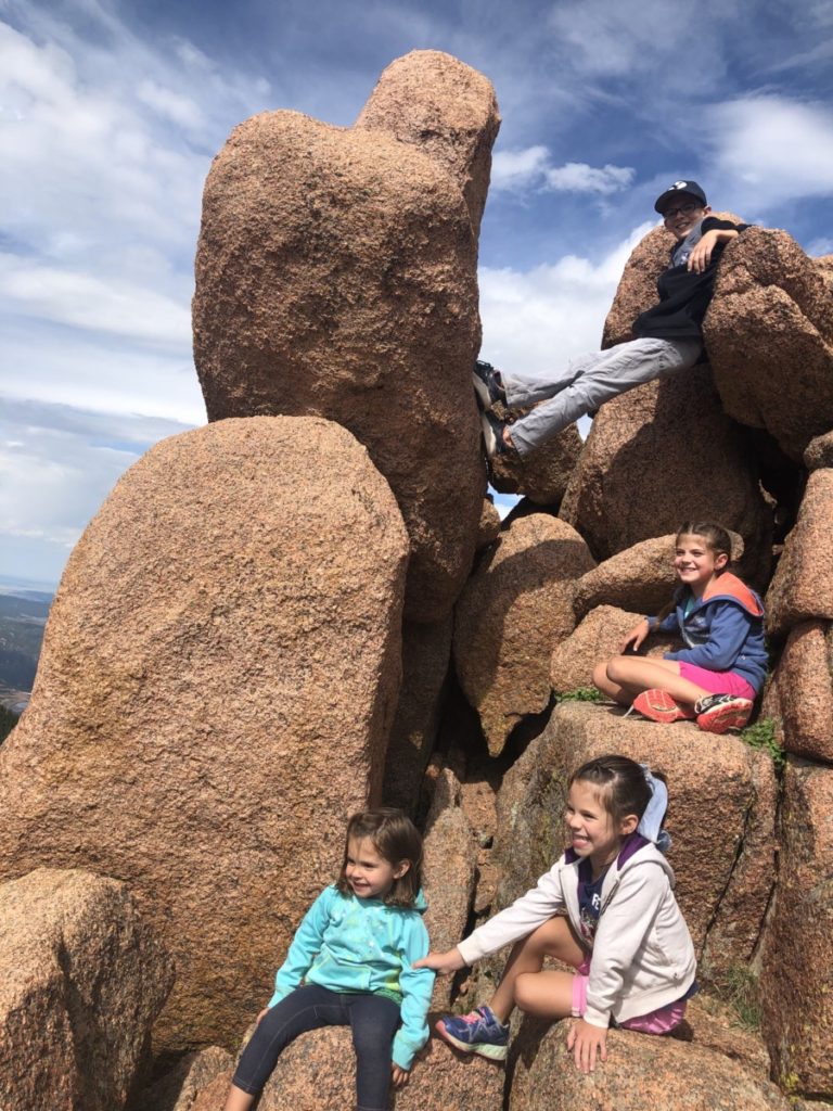 4 kids climbing boulders at Devil's Playground on Pike's Peak in Colorado Springs with Kids