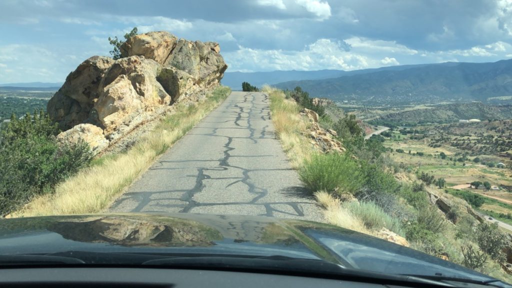 A Car drives the narrow ridge on Skyline Drive between Florence and Canon City