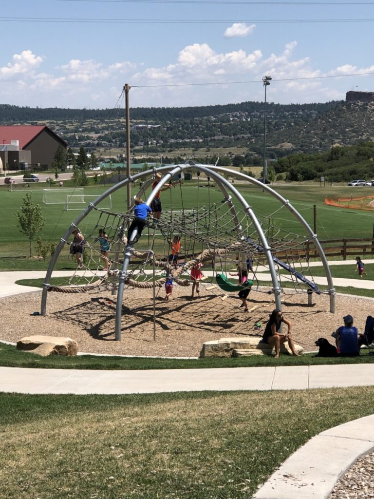 kids playing on the spider web net play area at Phillip Miller Park in Castle Rock, Colorado