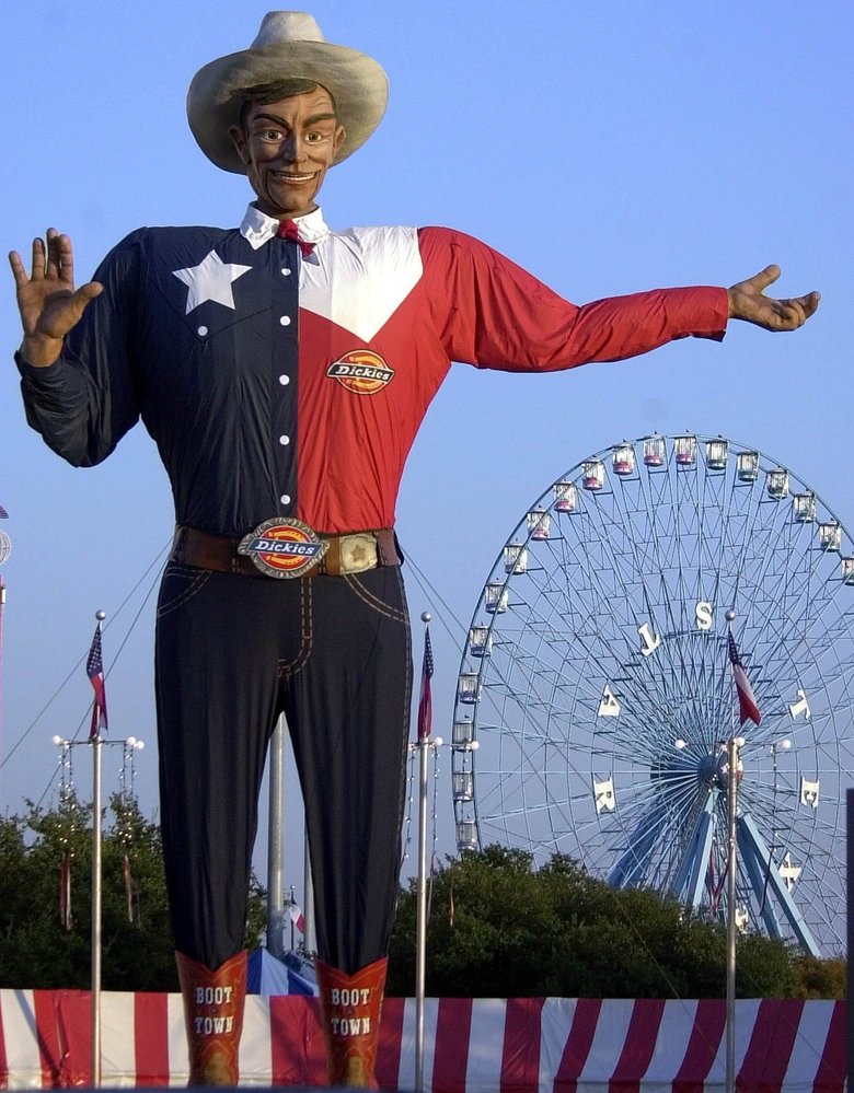 Big Tex in front of a Ferris Wheel at the Texas State Fair