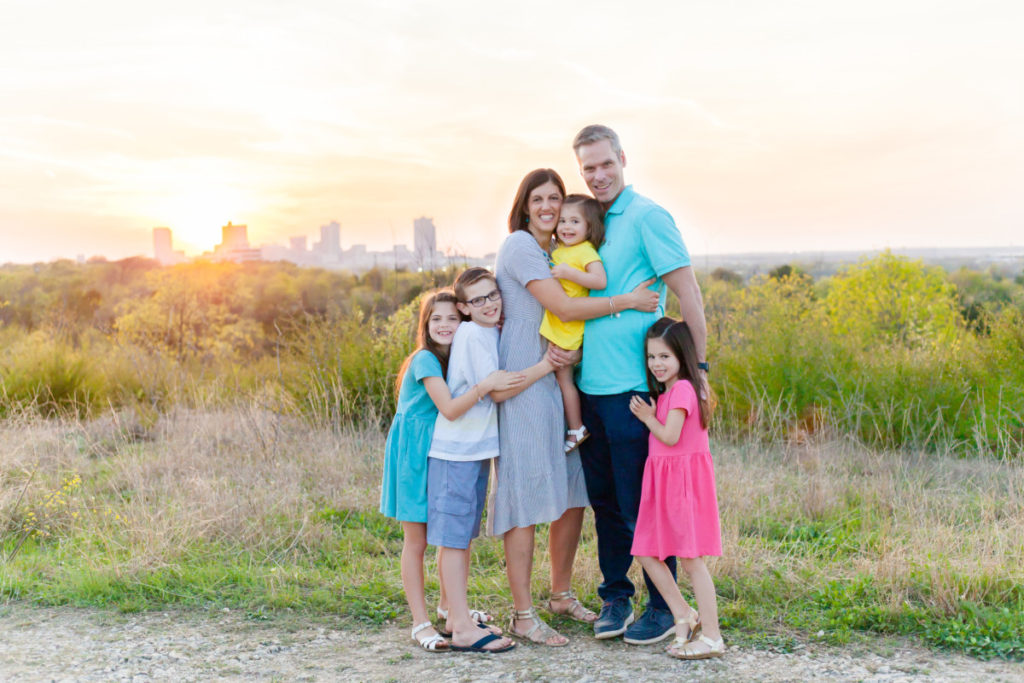 Family of 6 in Tandy Hills Natural Area with Fort Worth cityscape in the background