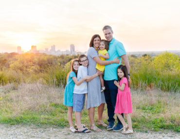 Family of 6 in Tandy Hills Natural Area with Fort Worth cityscape in the background