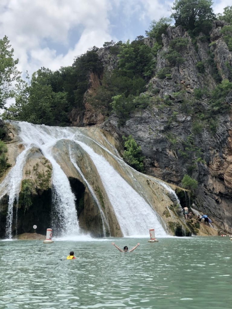A woman and son Swim in the pool below Turner Falls, Oklahoma