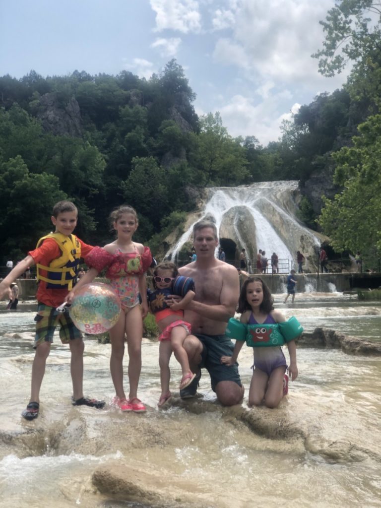 Dad and 4 kids in front of Turner Falls