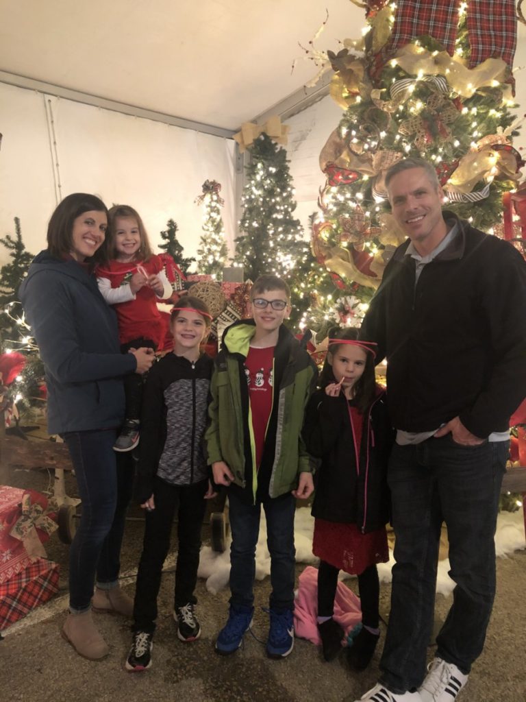 Family of 6 in front of Christmas Decor at Prairie Lights