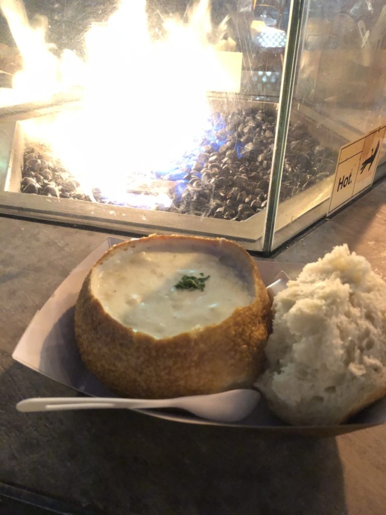 Clam Chowder in a Bread Bowl in front of a fire in Fisherman's Wharf San Francisco