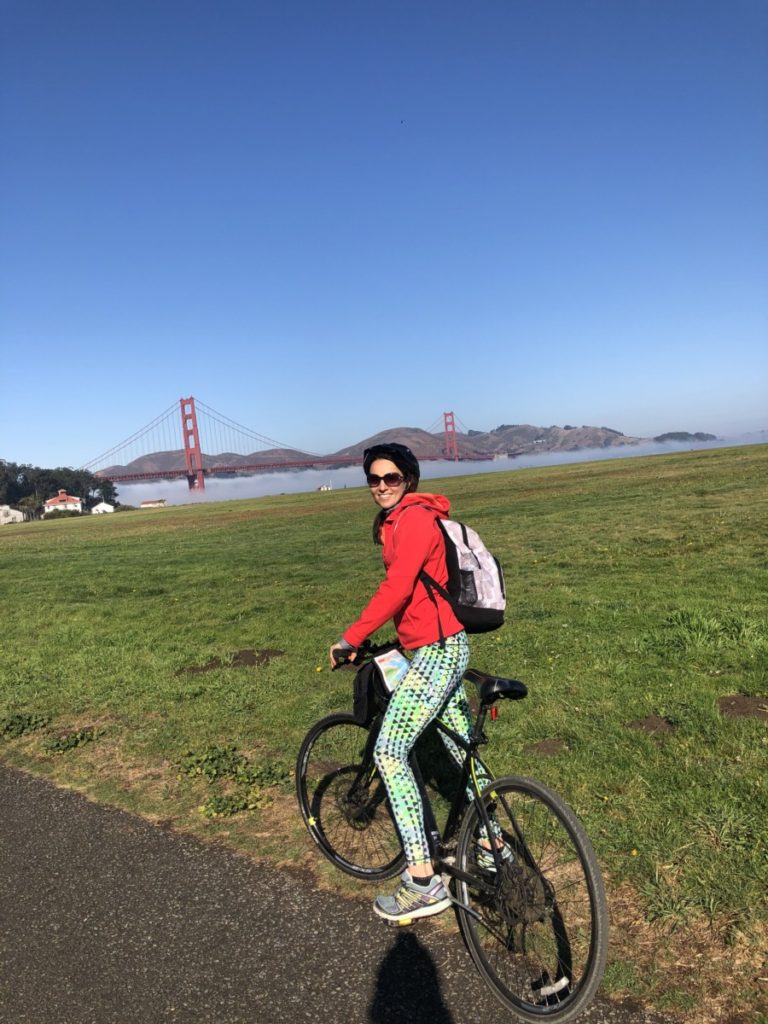 a woman Biking on the way to Golden Gate Bridge San Francisco