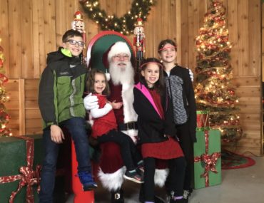 4 kids with Santa at Prairie Lights