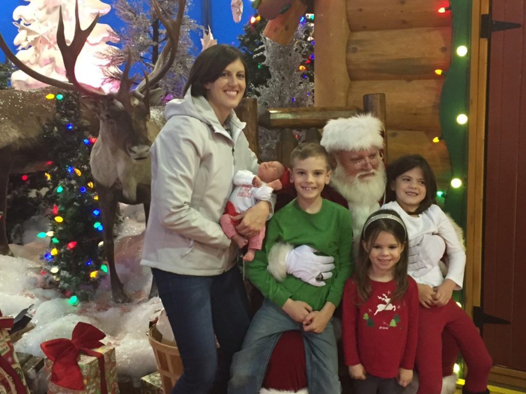 Bass Pro Santa with 4 kids and mom.