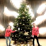 2 girls stand in front of the Christmas tree having family fun at the Westin DFW airport