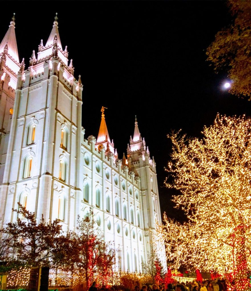 Salt Lake City Temple in the dark with christmas lights on the trees