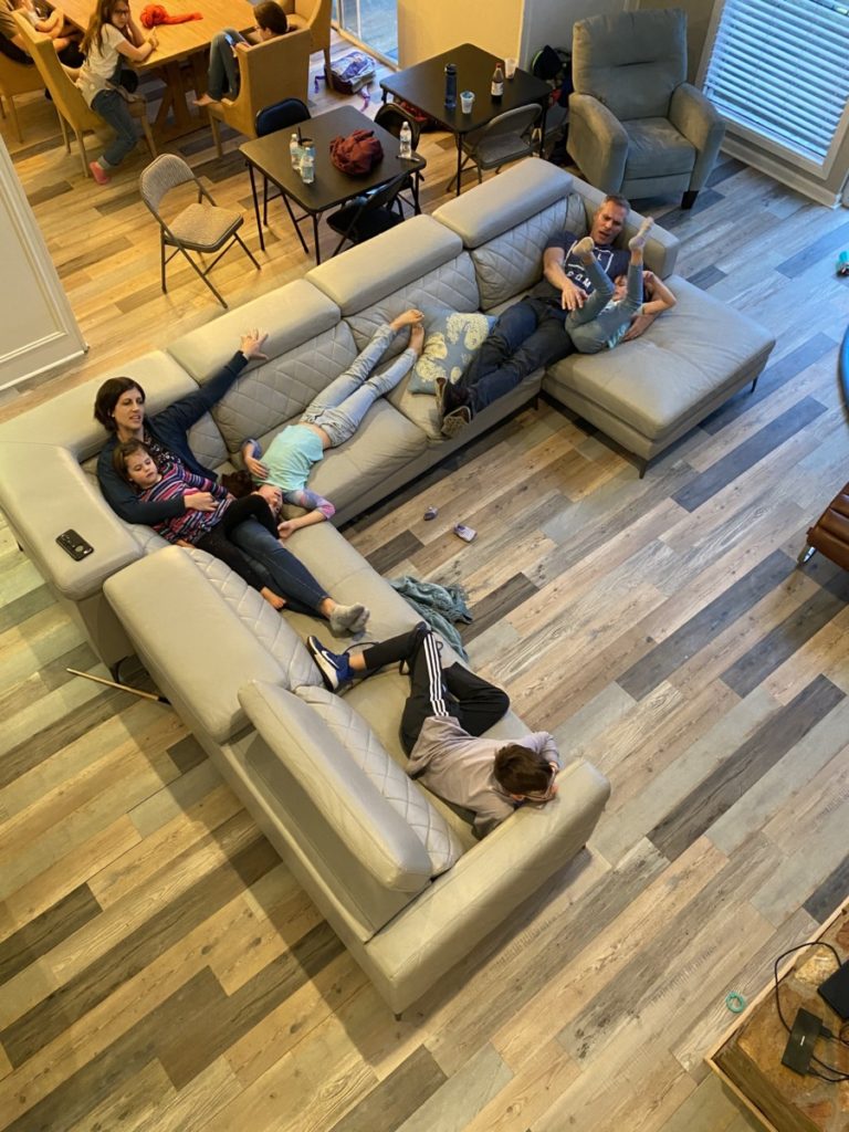 Family of 6 relaxing on the couch at Simply the Best Texoma Luxury Rental Property