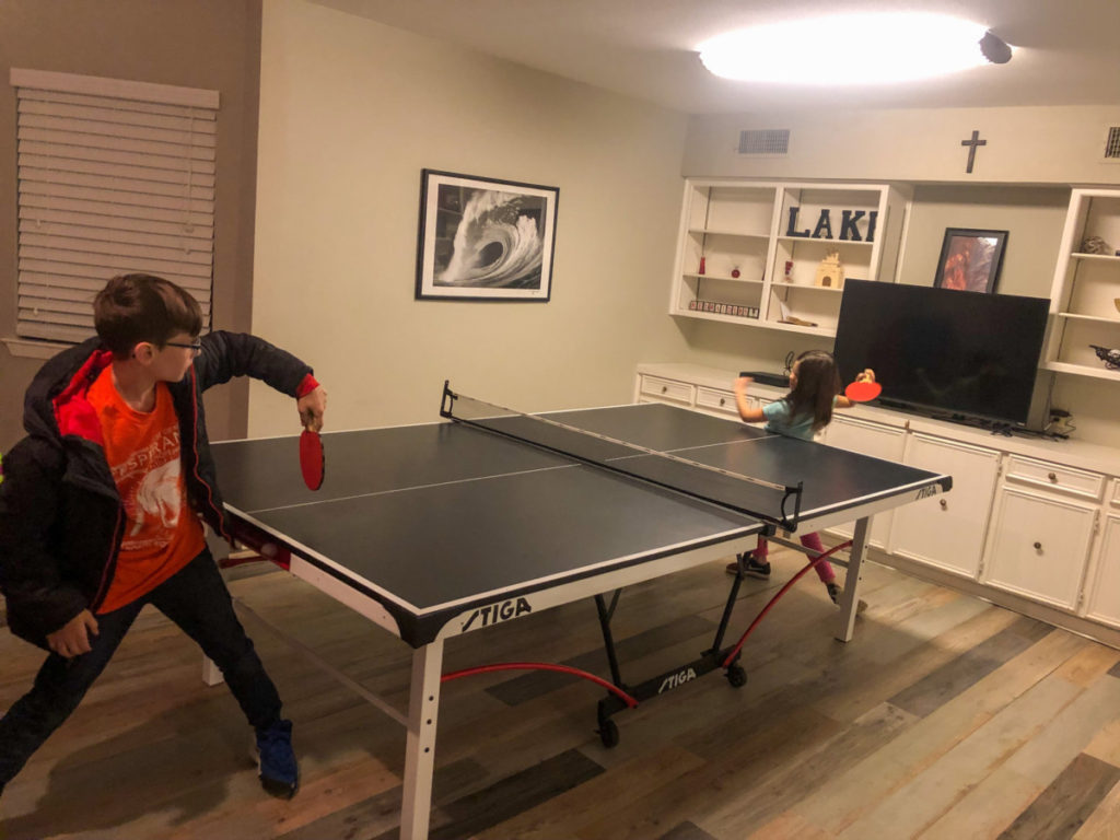2 kids play ping pong at Texoma Luxury Rentals