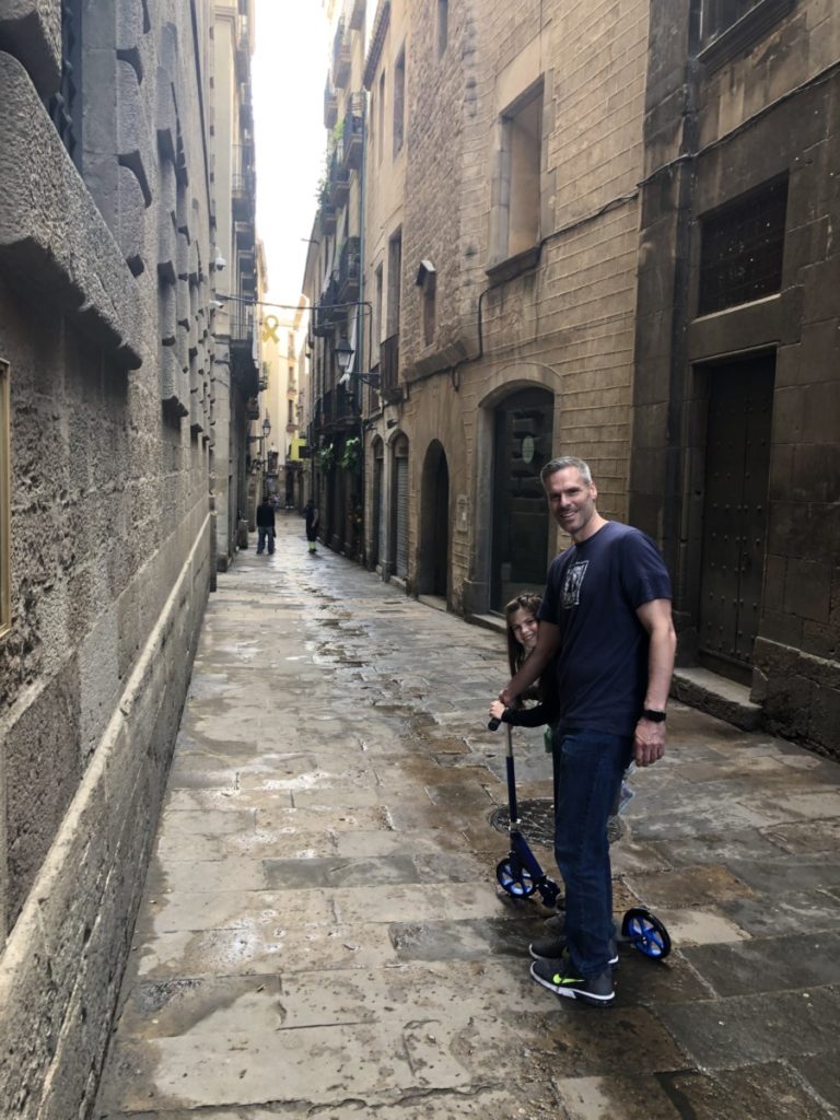 Dad and Daughter scoot through the Gothic Quarter in Barcelona